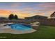 Inviting backyard pool with a rock waterfall feature at 14953 W Cortez St, Surprise, AZ 85379