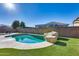 Relaxing kidney shaped pool with a rock waterfall feature at 14953 W Cortez St, Surprise, AZ 85379