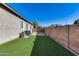 Artificial turf side yard with a block wall and gate at 14953 W Cortez St, Surprise, AZ 85379