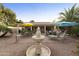 Relaxing backyard oasis with patio furniture, fountain, and shade umbrellas at 24404 S Boxwood Dr, Sun Lakes, AZ 85248