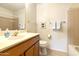 Clean bathroom with a tub, shower, and wood vanity at 24404 S Boxwood Dr, Sun Lakes, AZ 85248