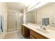 Bright bathroom with double sinks, shower, and ample storage at 24404 S Boxwood Dr, Sun Lakes, AZ 85248