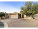 House with a two-car garage and mature tree in the front yard at 24404 S Boxwood Dr, Sun Lakes, AZ 85248