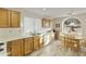 Bright kitchen with wood cabinets, tiled floor, and breakfast nook at 24404 S Boxwood Dr, Sun Lakes, AZ 85248