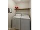 Laundry room with washer, dryer, and overhead shelving at 24404 S Boxwood Dr, Sun Lakes, AZ 85248