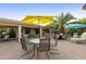 Outdoor patio with seating and yellow umbrella at 24404 S Boxwood Dr, Sun Lakes, AZ 85248