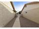 Pathway between houses leading to a shared pool at 24404 S Boxwood Dr, Sun Lakes, AZ 85248