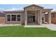The house boasts a well-manicured lawn with a covered patio, seamlessly blending indoor and outdoor living at 32962 N 131St Dr, Peoria, AZ 85383