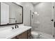 Modern bathroom featuring a glass shower, white countertop, and sleek dark fixtures for a stylish look at 32962 N 131St Dr, Peoria, AZ 85383
