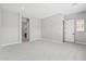 Spacious bedroom with neutral colors, featuring doorways to a bathroom and hallway at 32962 N 131St Dr, Peoria, AZ 85383