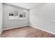 Cozy bedroom with wood-look floors and a bright window view at 32962 N 131St Dr, Peoria, AZ 85383