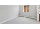 Bright bedroom featuring soft carpeting and a view of the backyard at 32962 N 131St Dr, Peoria, AZ 85383