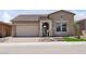 Charming single-Gathering home featuring desert landscaping, a two-car garage, and a welcoming entrance at 32962 N 131St Dr, Peoria, AZ 85383