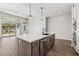 Kitchen island with stainless steel appliances and quartz countertops at 32962 N 131St Dr, Peoria, AZ 85383