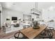 Open concept living room and kitchen space with hardwood floors, an island, and comfortable seating at 32962 N 131St Dr, Peoria, AZ 85383