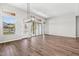 Spacious living room featuring hardwood floors, sliding doors and multiple windows that fill the room with natural light at 32962 N 131St Dr, Peoria, AZ 85383