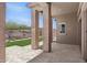 Open-air patio with tiled flooring and sturdy support columns, providing a relaxed outdoor living space at 32962 N 131St Dr, Peoria, AZ 85383