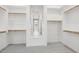 Organized walk-in closet with ample storage space and neutral carpeting at 32962 N 131St Dr, Peoria, AZ 85383