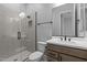 Modern bathroom featuring neutral tile shower, updated vanity, black hardware, and modern fixtures at 32994 N 131St Dr, Peoria, AZ 85383