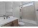 Well-lit bathroom featuring tub and shower, single sink vanity, and tile details at 32994 N 131St Dr, Peoria, AZ 85383