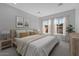 Bright bedroom with large windows, neutral tones, and minimalist decor at 32994 N 131St Dr, Peoria, AZ 85383
