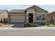 Charming single-story home featuring stone accents, a two-car garage, and well-maintained landscaping at 32994 N 131St Dr, Peoria, AZ 85383