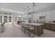 Modern kitchen with a large island, stainless steel appliances, and an adjacent dining area at 32994 N 131St Dr, Peoria, AZ 85383
