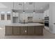 Modern kitchen with stainless steel appliances, custom cabinets, and an oversized island at 32994 N 131St Dr, Peoria, AZ 85383
