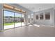 Sunlit living room featuring large sliding doors, neutral tones, and backyard views at 32994 N 131St Dr, Peoria, AZ 85383