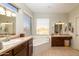 The luxurious bathroom has a soaking tub with a window, dual vanities, and neutral tile at 3650 N Barron --, Mesa, AZ 85207