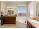 Bright bathroom with large windows over tub, double sinks, and neutral decor at 3650 N Barron --, Mesa, AZ 85207