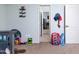 room featuring gray bed, carpeted floor, and doorway leading to another room at 3650 N Barron --, Mesa, AZ 85207