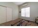 A carpeted bedroom with a window, closet and a mini split system for personalized climate control at 3650 N Barron --, Mesa, AZ 85207