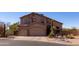 Inviting two-story home boasts a spacious three-car garage and desert landscaping at 3650 N Barron --, Mesa, AZ 85207