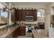 Kitchen featuring stainless steel appliances, dark wood cabinetry, granite countertops, and natural light at 3650 N Barron --, Mesa, AZ 85207