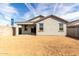 View of the home's backyard featuring dirt and a covered patio at 8584 N 170Th Ln, Waddell, AZ 85355