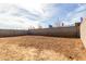 View of the home's backyard showing dirt and a block fence at 8584 N 170Th Ln, Waddell, AZ 85355