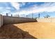 View of the home's backyard showing dirt and a block fence at 8584 N 170Th Ln, Waddell, AZ 85355