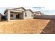 View of the home's backyard showing dirt and a covered patio at 8584 N 170Th Ln, Waddell, AZ 85355