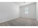 Bright bedroom featuring a window for natural light and neutral colored carpeting at 8584 N 170Th Ln, Waddell, AZ 85355