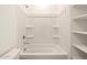 Bathroom with shower/tub combo and shelving at 9109 N 173Rd Ln, Waddell, AZ 85355