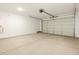 Spacious garage with light-colored flooring and an automatic garage door at 9109 N 173Rd Ln, Waddell, AZ 85355