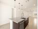 Kitchen island with a farmhouse sink and granite countertop at 9109 N 173Rd Ln, Waddell, AZ 85355