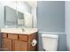 Close-up of a half bathroom featuring wood vanity with sink and standard toilet at 1335 E June St # 239, Mesa, AZ 85203