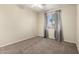 Carpeted bedroom featuring a ceiling fan and window with curtains and blinds letting in natural light at 1335 E June St # 239, Mesa, AZ 85203