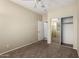 Carpeted bedroom featuring a closet with mirrored doors, ceiling fan and a window for natural light at 1335 E June St # 239, Mesa, AZ 85203