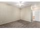 Spacious carpeted bedroom with a ceiling fan and an entrance to an ensuite bathroom and a closet at 1335 E June St # 239, Mesa, AZ 85203