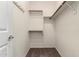 Walk in closet features carpet flooring, white walls and shelving to maximize storage at 1335 E June St # 239, Mesa, AZ 85203