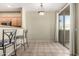 Bright dining area featuring tile flooring, an overhead light fixture, and sliding glass doors to the outside patio at 1335 E June St # 239, Mesa, AZ 85203