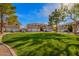 Well-maintained condo exterior with green grass and ample parking spaces at 1335 E June St # 239, Mesa, AZ 85203